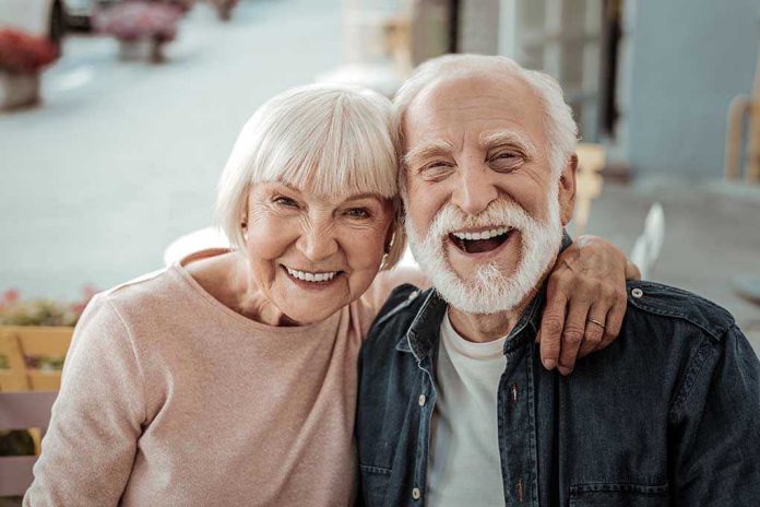 1565185228 Elderly couple smiling together outdoors.