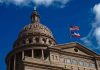Building dome with US and Texas flags