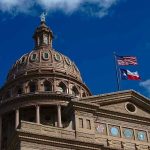 Building dome with US and Texas flags