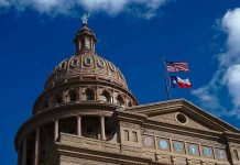 Building dome with US and Texas flags