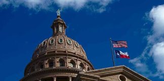 Building dome with US and Texas flags