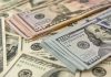 Stacks of various U.S. dollar bills