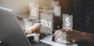 Person typing on laptop with tax-related icons displayed