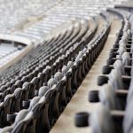 Empty rows of gray seats in a stadium