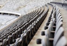 Empty rows of gray seats in a stadium