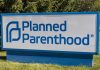 Planned Parenthood sign on a grassy lawn