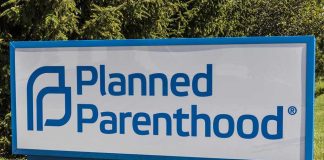 Planned Parenthood sign on a grassy lawn