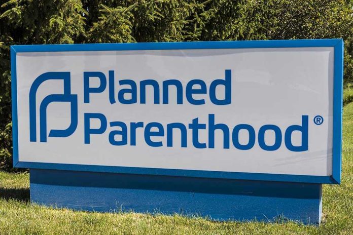 Planned Parenthood sign on a grassy lawn