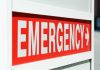 Emergency sign indicating direction with a red background and white text