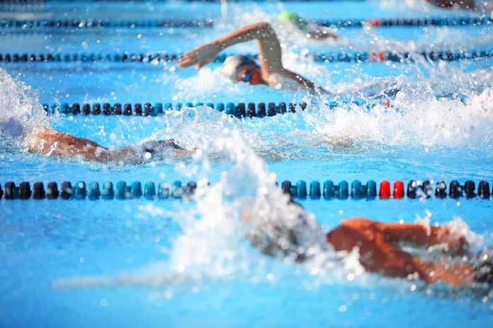 shutterstock_106533593.jpg Swimmers competing in a pool creating splashes of water