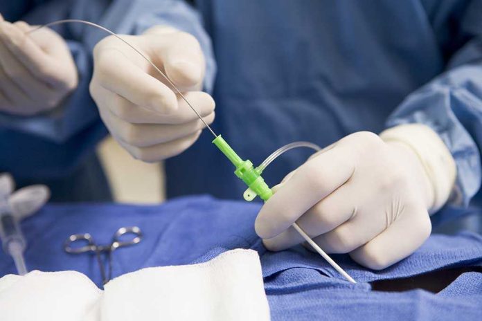 Medical professional preparing an intravenous catheter in a sterile setting