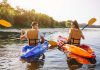 Two people kayaking on a sunny river
