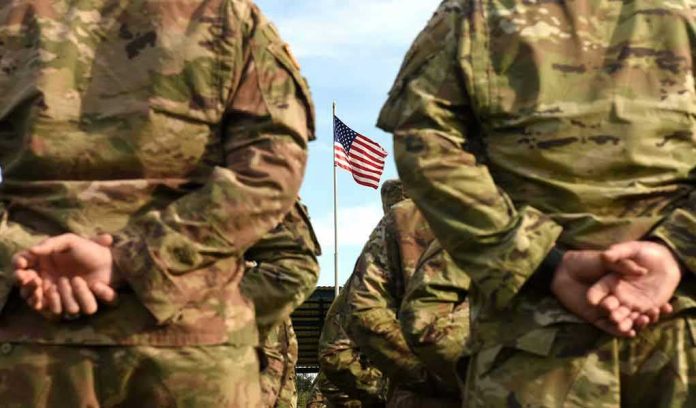 1507031819 Soldiers stand in formation with American flag in background.
