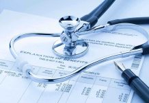 A stethoscope resting on a medical billing statement