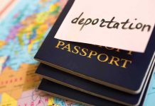 Stack of passports with a note labeled 'deportation' on top, placed on a map