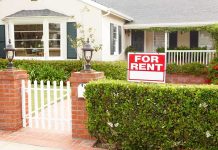 A house with a For Rent sign in the front yard