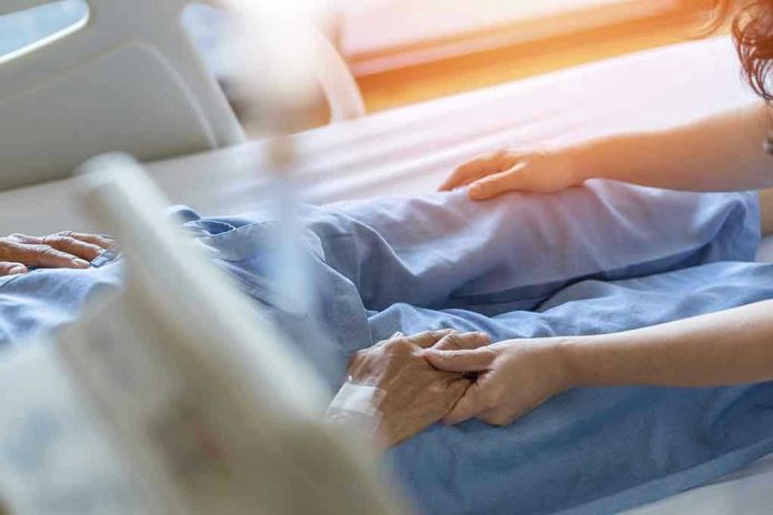 Hospital patient holding visitors hand reassuringly
