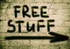 Graffiti on brick wall says free stuff arrow
