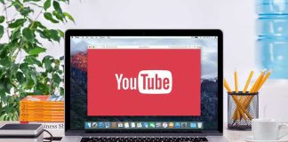 YouTube logo on a laptop screen on desk
