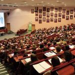 Students seated in a lecture hall listening to a presentation