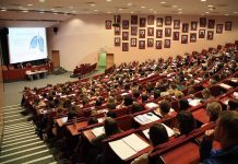 Students seated in a lecture hall listening to a presentation
