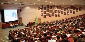 Students seated in a lecture hall listening to a presentation