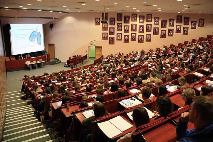 shutterstock_132834815.jpg Students seated in a lecture hall listening to a presentation
