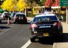 Police cars and school buses on a road
