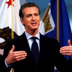 Newsom BETRAYS Citizens — Shields Big Tech Man speaking with flags in the background