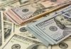 Stacks of various US dollar bills