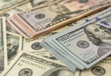 Stacks of various US dollar bills