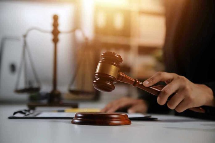 2478909667 Gavel being struck near scales of justice
