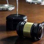 Nassau Officials Defy Court – Legal Chaos Looms Gavel and scales of justice on wooden table