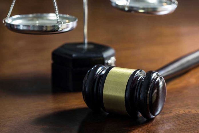 526372696 Gavel and scales of justice on wooden table