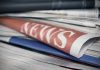 Stack of newspapers with NEWS headline visible