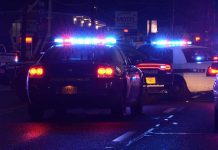 Police Chief SIDELINED—Outrage Over Media Bias Police cars with flashing lights at a nighttime scene near a motel