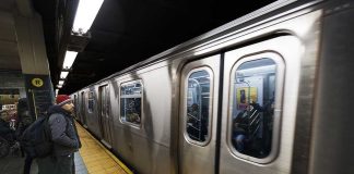 Subway Slasher Freed—Judge Under Fire A commuter waiting at a subway station as a train approaches