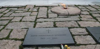 Memorial site for John F Kennedy featuring a grave marker and an eternal flame