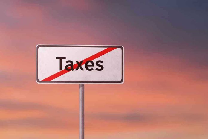 1135828310 Sign with the word Taxes crossed out.