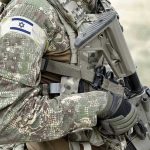 Soldier in camouflage gear with Israeli flag patch