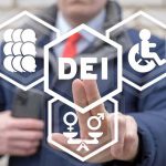 Person pointing at DEI symbols on glass