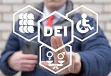 Person pointing at DEI symbols on glass