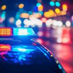 Police car with flashing lights at night