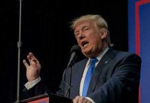 TRUMP Freezes Food Aid — Millions Left Waiting Person speaking into microphone at a podium