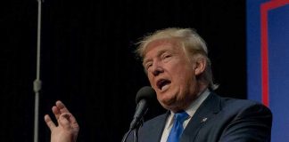 TRUMP Freezes Food Aid — Millions Left Waiting Person speaking into microphone at a podium