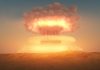 Nuclear Threat: Putin Aggressively Responds to Trump A nuclear explosion creating a large mushroom cloud against a sunset sky