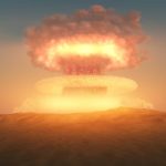 A nuclear explosion creating a large mushroom cloud against a sunset sky