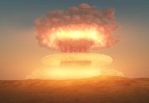 A nuclear explosion creating a large mushroom cloud against a sunset sky