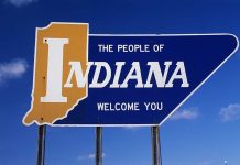Welcome sign for the state of Indiana against a blue sky
