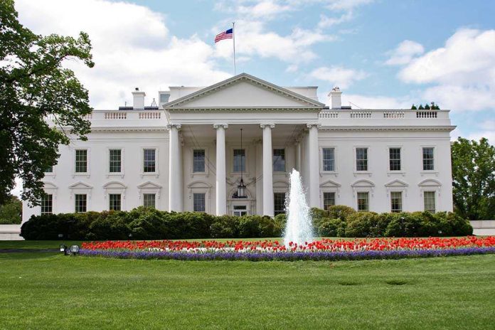 The White House surrounded by colorful flower beds and a fountain